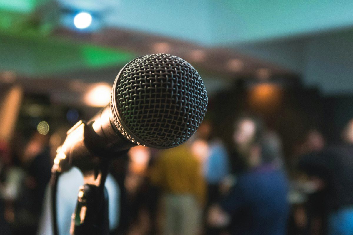 Microphone on stage in front of an audience