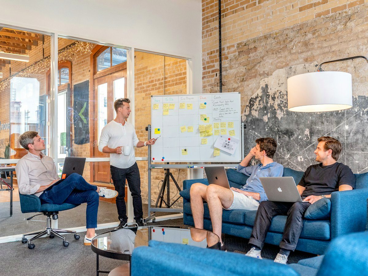 Team rehearsing a pitch in a creative studio